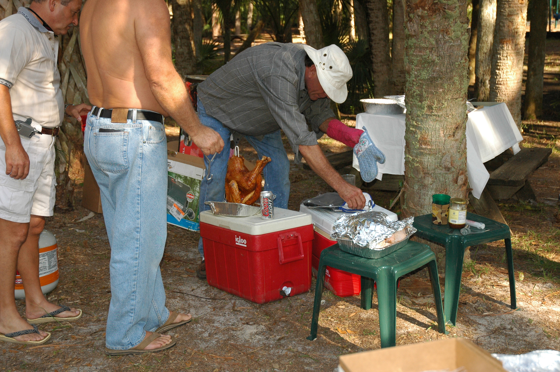 Tim oversees a frying turkey with fellow pilgrims